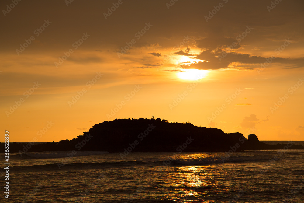 Sunset over a small island off the beaches of Punta Mita, Mexico