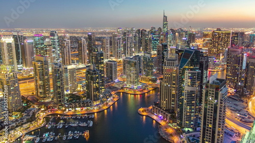 Dubai Marina with modern towers from top of skyscraper transition from day to night timelapse © neiezhmakov