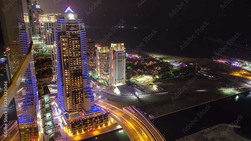 Night view on hotels and bridge with traffic timelapse at Dubai Marina