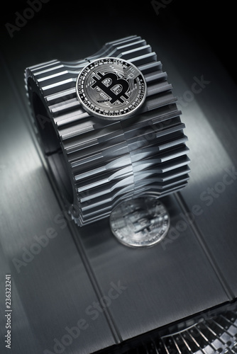 Bitcoin Silver coin lies on the gearwheel. photo