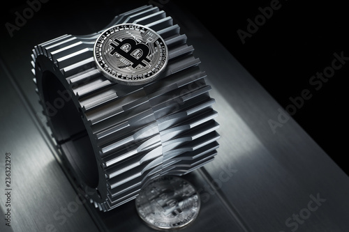 Bitcoin Silver coin lies on the gearwheel. photo