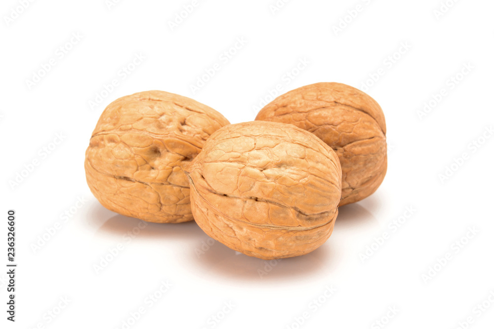 Three walnuts, close up macro, isolated on a white background. Three walnuts, close up macro, isolated on a white background.