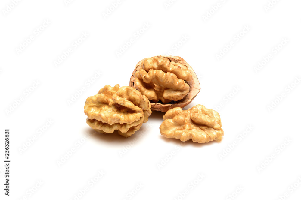Walnut and kernels, one open walnut and two kernels close up macro, isolated on a white background. Walnut and kernels, one open walnut and two kernels close up macro, isolated on a white background.