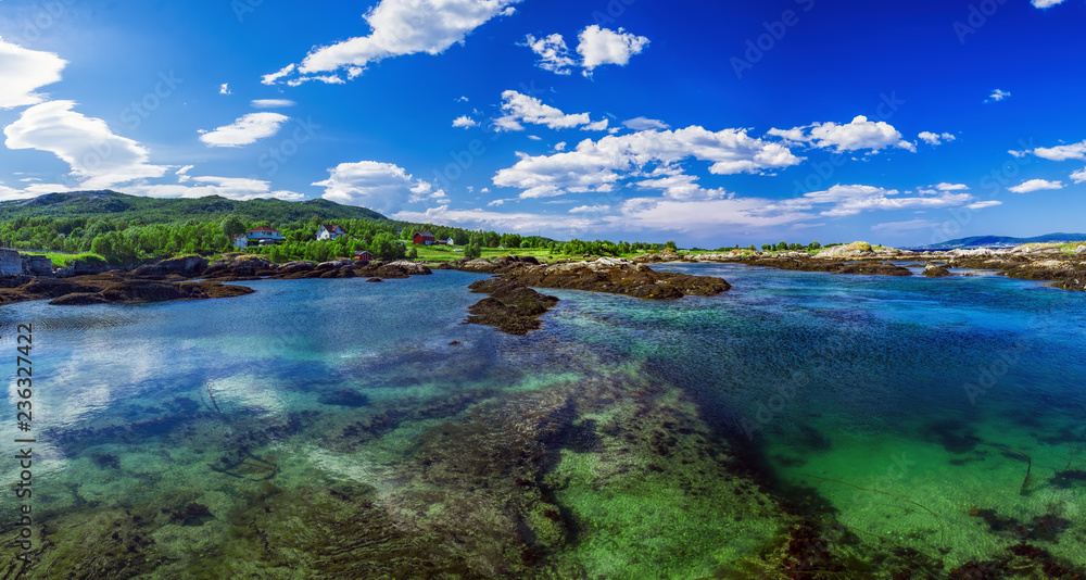 Picturesque panoramic view of Godoy Island in Giske Municipality in More og Romsdal county, Norway. Norwegian sea bay in summer scenery Picturesque panoramic view of Godoy Island in Giske Municipality in More og Romsdal county, Norway. Norwegian sea bay in summer scenery