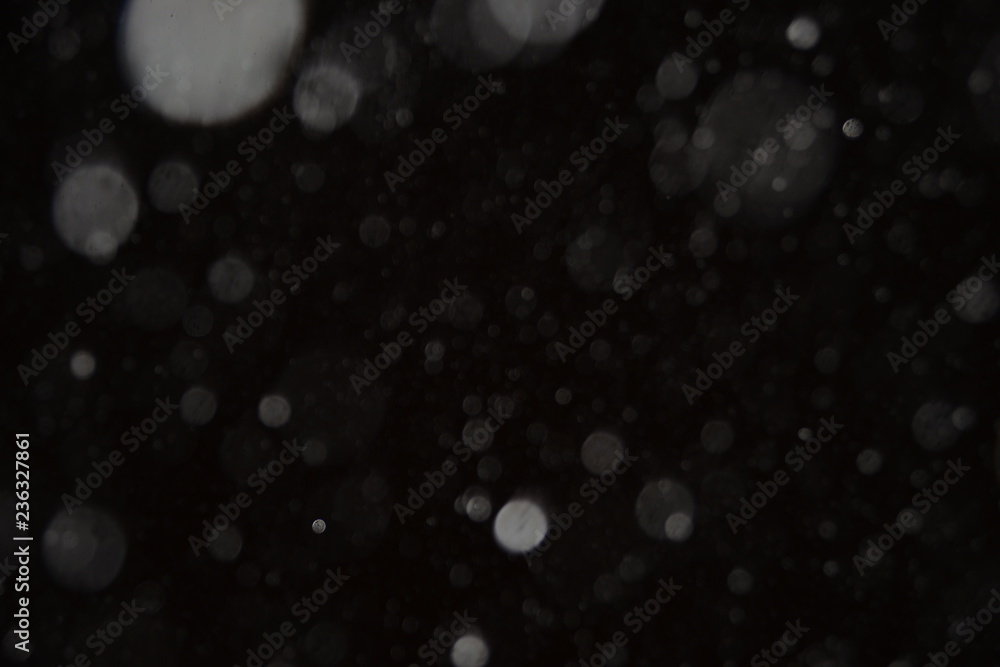 The texture of the flying snow on a black background. The texture of the flying snow on a black background.