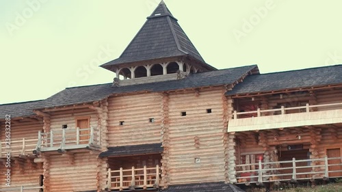 An ancient Slavic pagan city built of wood, excellent scenery for a historical film, old wooden churches and houses, an orthodox cross, summer time, no people in the frame, old Kiev photo