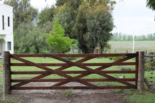 antique wooden gate closure at the entrance to the farm or ranch
