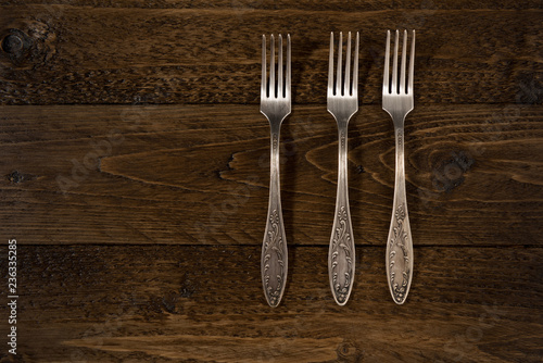 Set of vintage forks on a wooden background