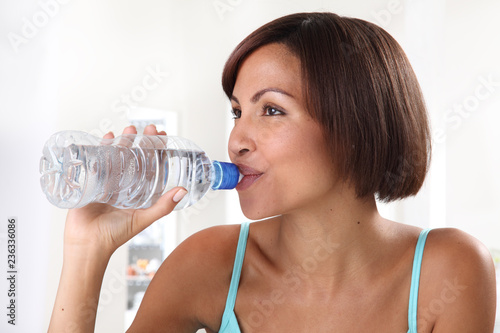 WOMAN DRINKING WATER FROM BOTTLE
