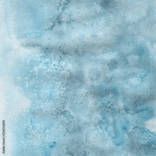 Blue watercolor winter texture with abstract washes and brush strokes on the white paper background.