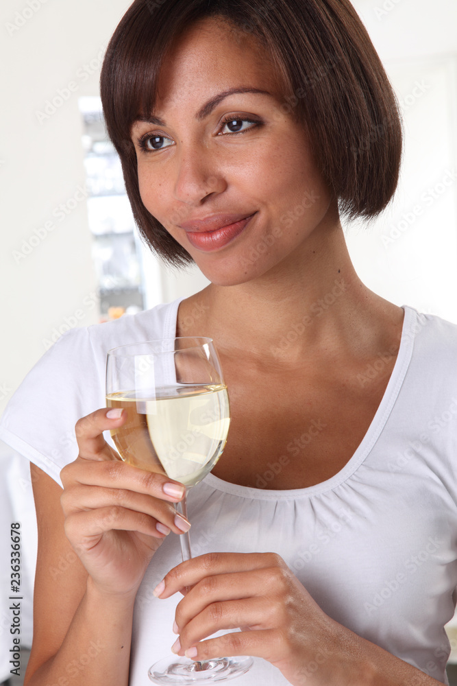 WOMAN HOLDING A GLASS OF WHITE WINE WOMAN HOLDING A GLASS OF WHITE WINE