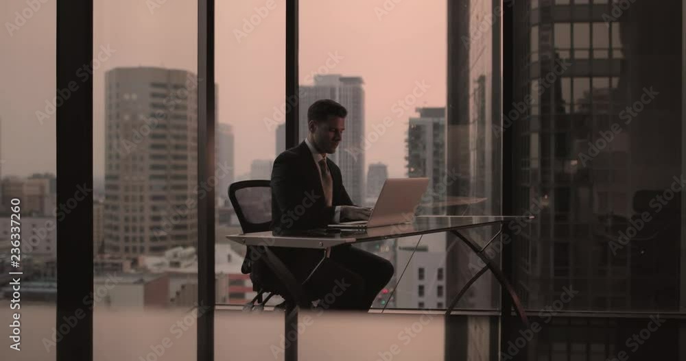 Businessman working in executive office in a skyscraper Businessman working in executive office in a skyscraper