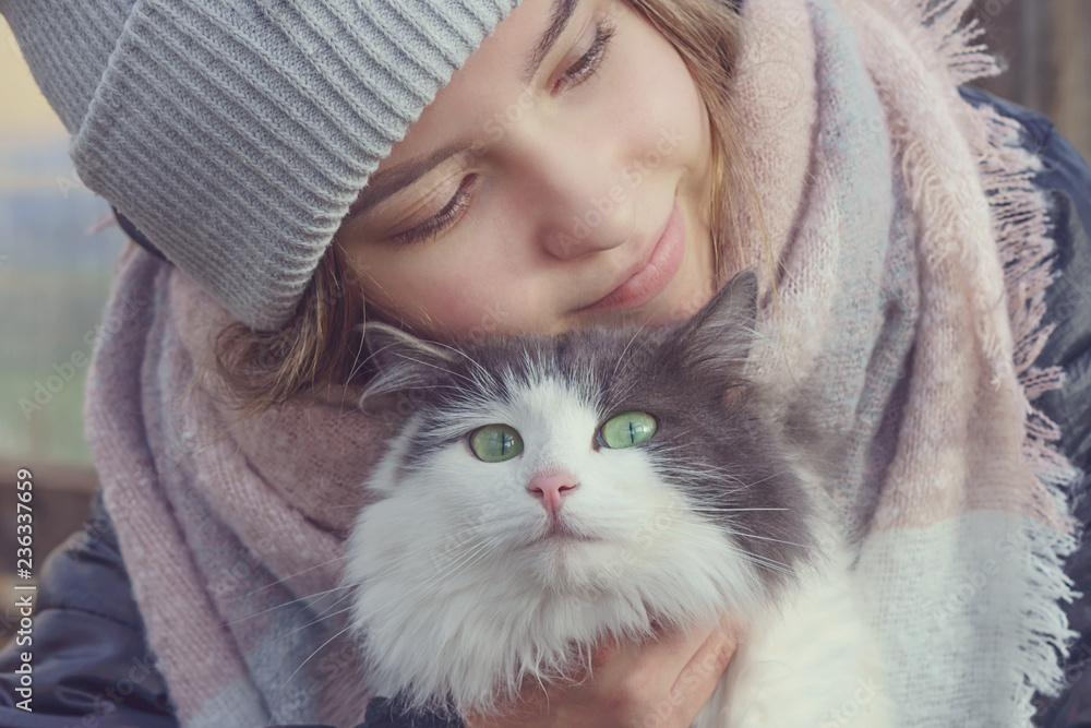 Girl holding a cat in her arms Girl holding a cat in her arms