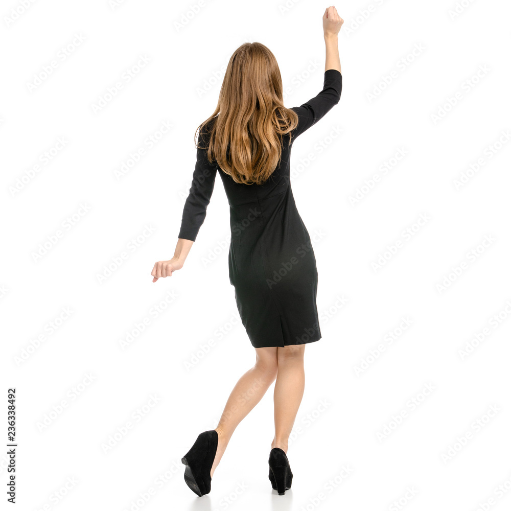 Beautiful woman in a dress business happy dancing on a white background back view isolation Beautiful woman in a dress business happy dancing on a white background back view isolation