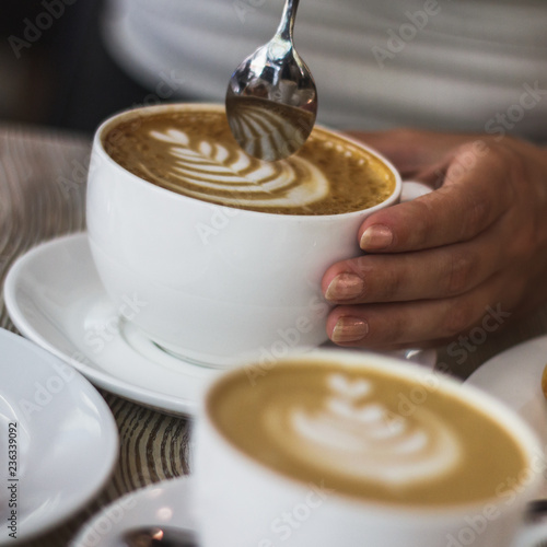 cup of coffee on a wooden table in a restaurant