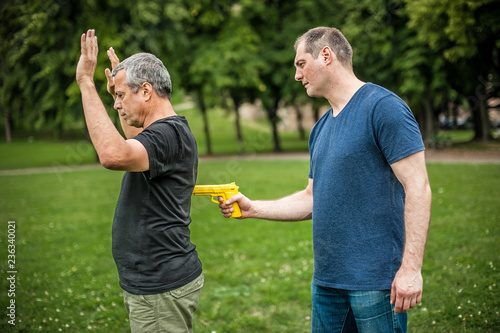 Gun point. Kapap instructor demonstrates self defense techniques against threat
