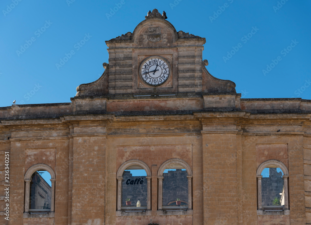 The clock on the roof of the building on Piazza Vittorio Veneto square blue sky background