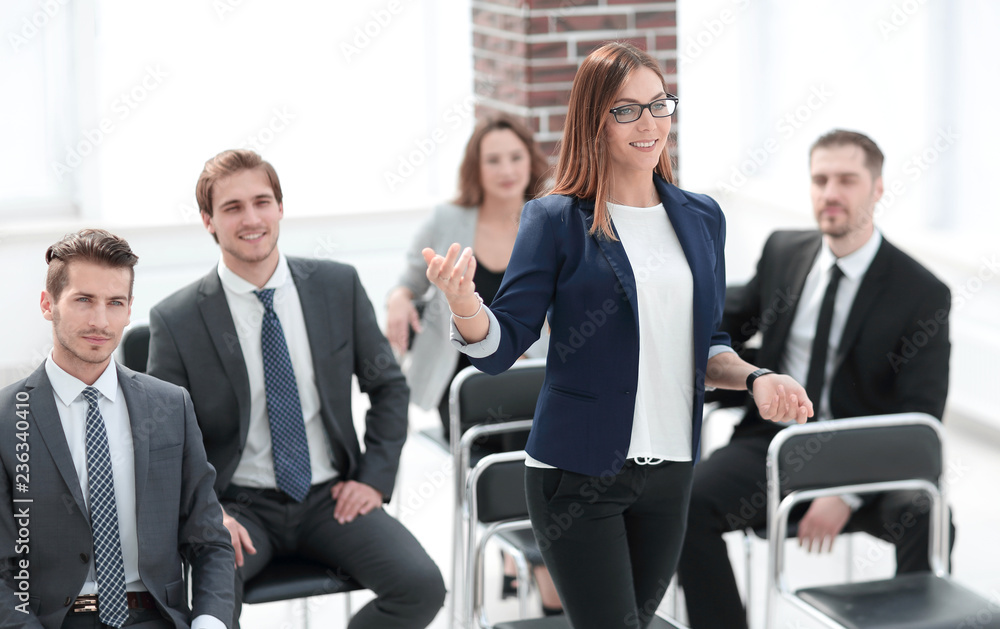 busines woman at business seminar takes a question busines woman at business seminar takes a question