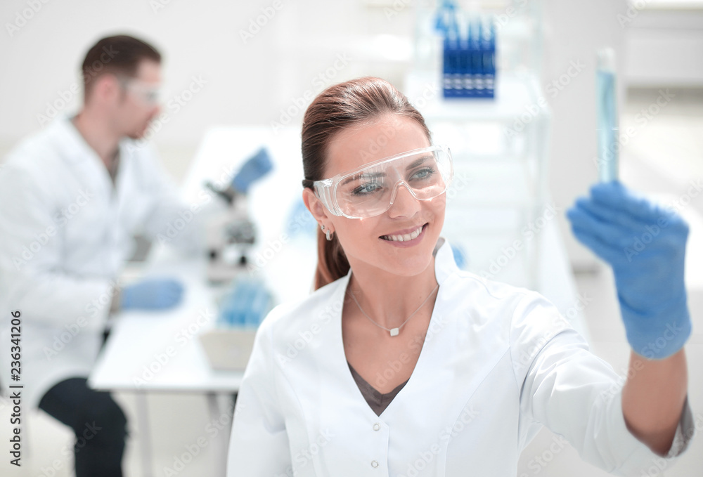 smiling female scientist standing in the lab smiling female scientist standing in the lab