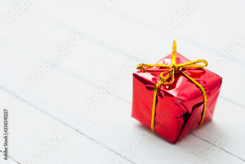 Red gift box on white wood