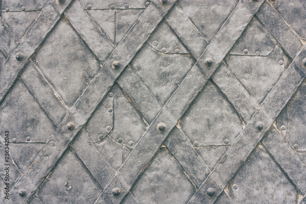 Obraz premium Old metal wrought door of medieval building close up, horizontal grunge background