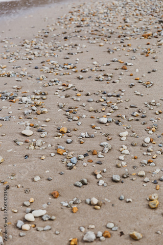 Pebbles on sandy beach
