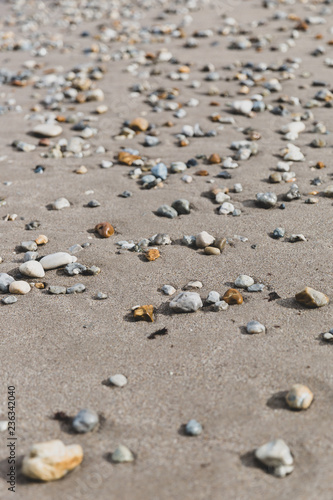 Pebbles on sandy beach
