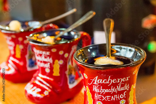 Traditional german holiday drink - punch (Feuerzangenbowle) in cup in the form of shoe with German text, translated as - Aachen Christmas Market Hexenhof (restaurant), Aachen, Germany, December, 2017 photo