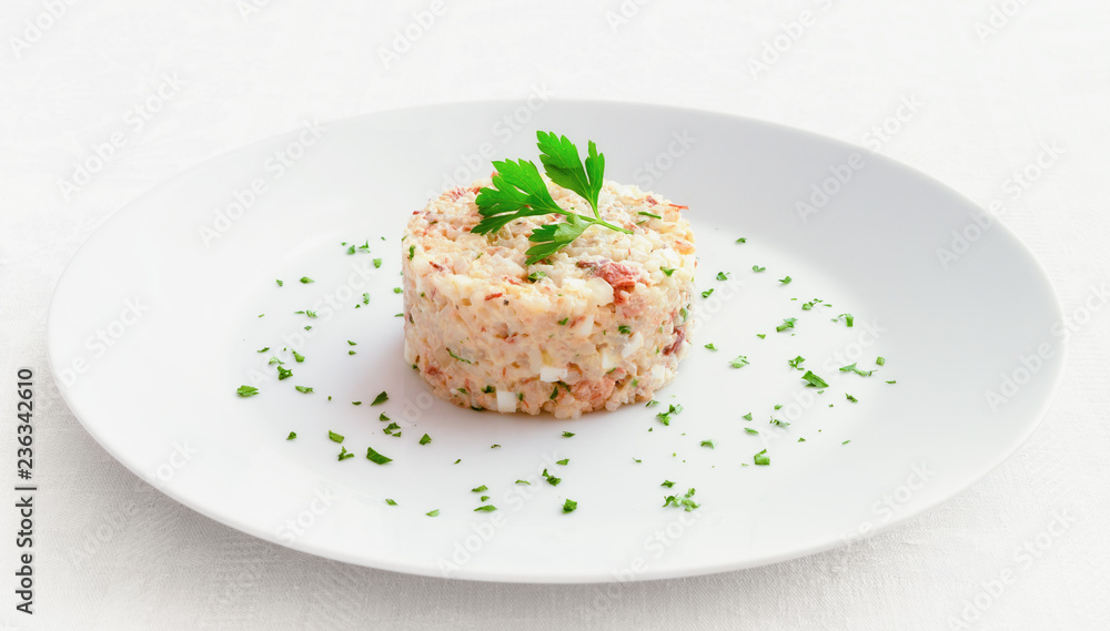 mayonnaise salad with mackerel, egg, onion and rice decorated with parsley