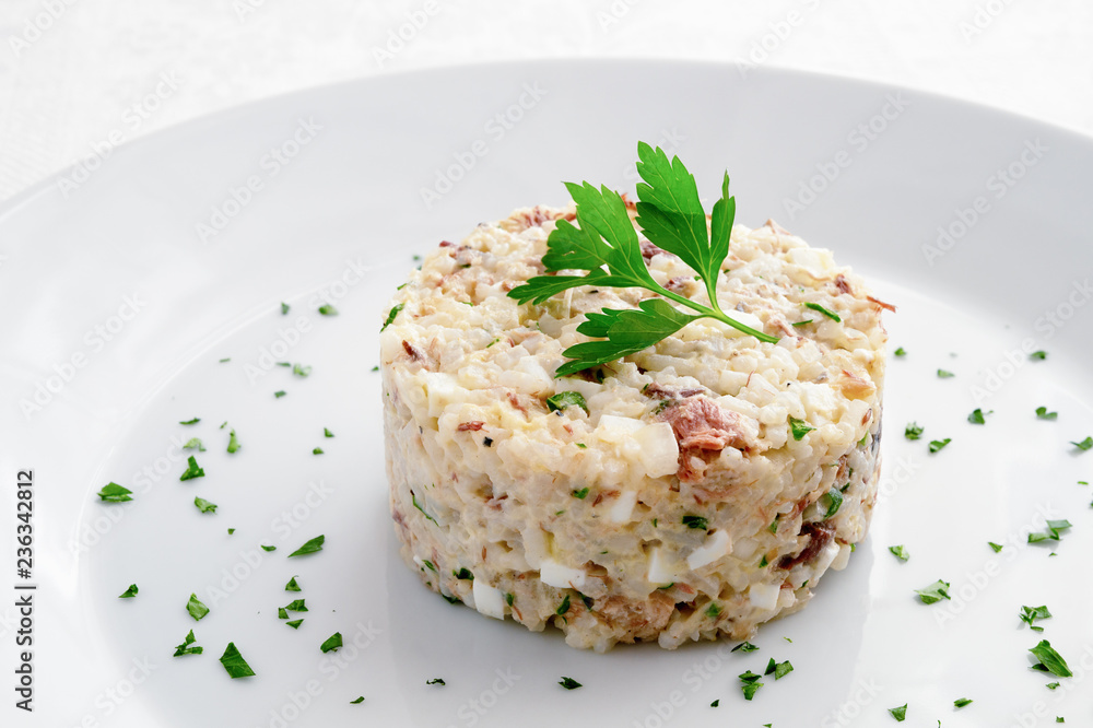 mackerel salad with egg, onion and rice dressed with mayo sauce and decorated with parsley mackerel salad with egg, onion and rice dressed with mayo sauce and decorated with parsley