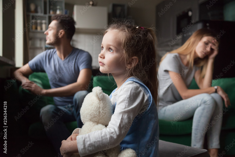 © fizkes - Upset frustrated little girl tired of parent fight, toddler daughter holding toy dreaming that family conflicts would stop, suffering from mother and father quarrels, bad family relationship, break up © fizkes - Upset frustrated little girl tired of parent fight, toddler daughter holding toy dreaming that family conflicts would stop, suffering from mother and father quarrels, bad family relationship, break up
