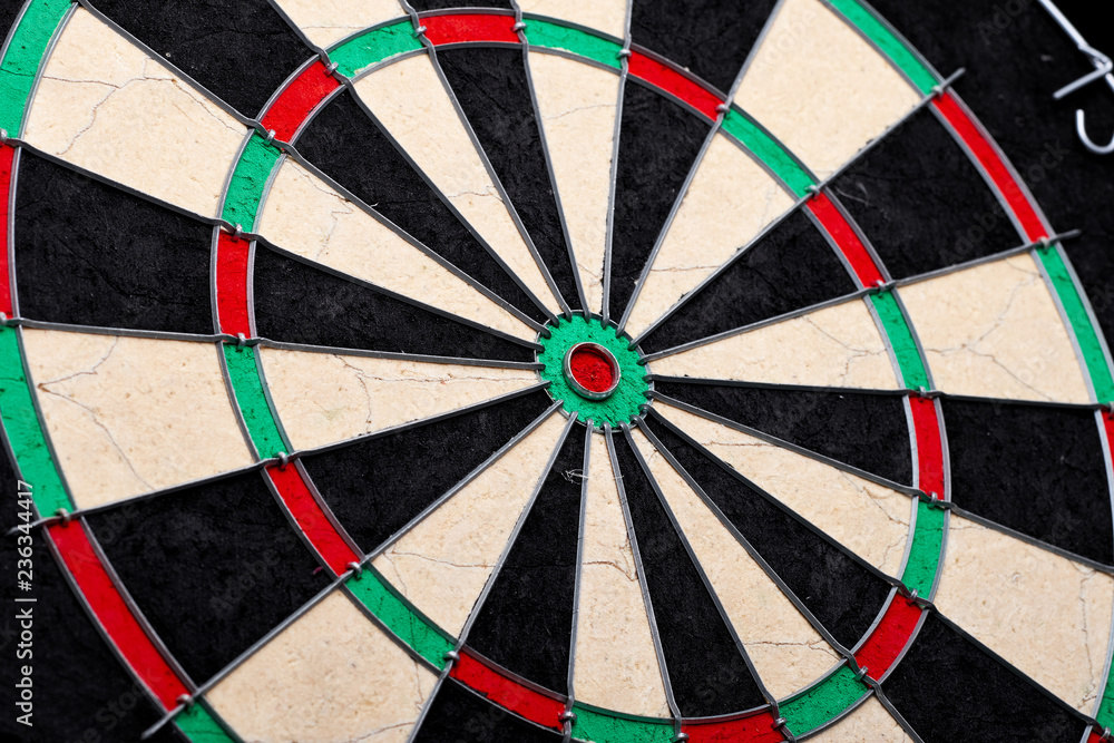 Hitting in the target center of dartboard. Targeting the business concept. Bullseye of a Dartboard Hitting in the target center of dartboard. Targeting the business concept. Bullseye of a Dartboard