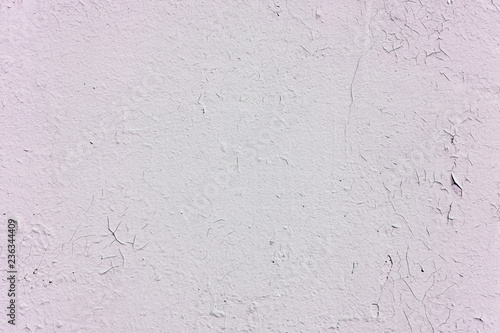 Natural background. Wall with a shabby and peeling paint, crack and plaster. pink and white