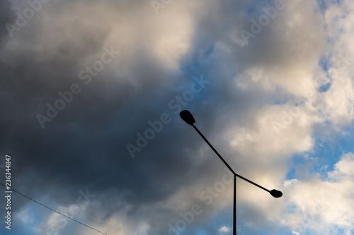 Street lamp against a background of sky and puffy clouds. Street light against blue sky and beautiful clouds. 