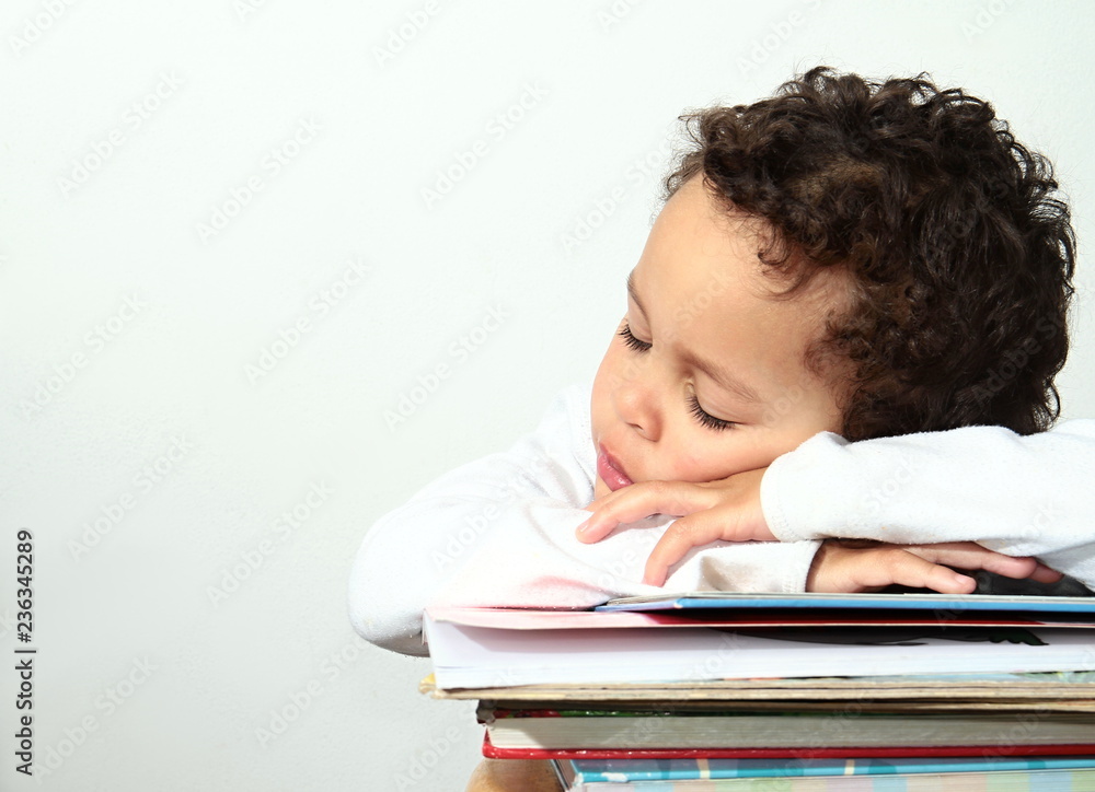 little boy sleeping on a pile of books little boy sleeping on a pile of books