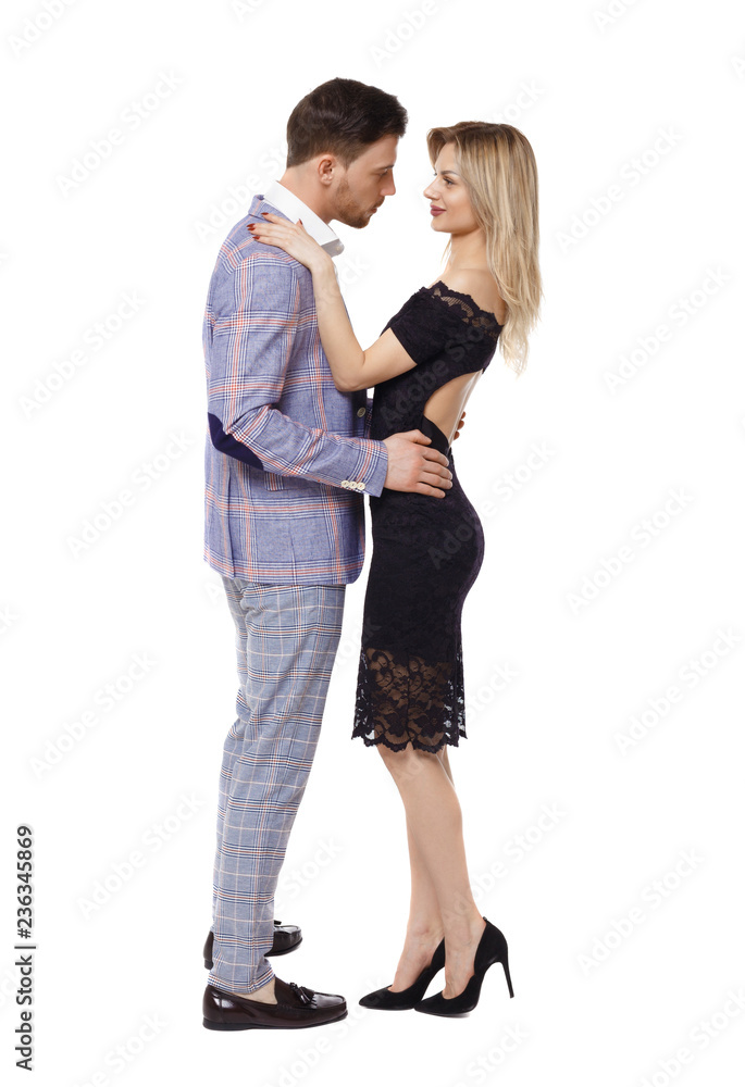 Side view of a hugging couple in evening outfits. Side view of a hugging couple in evening outfits.
