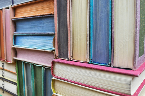 Many old books stacked in texture