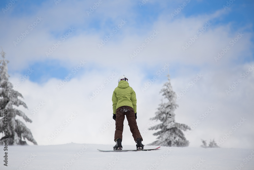 Woman on snowboard in mountains
