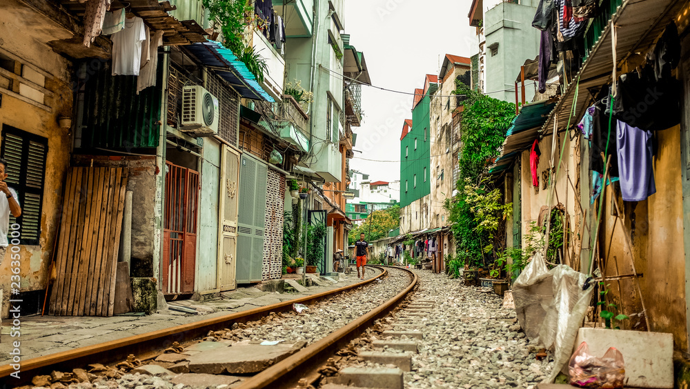 Fototapeta premium A train track running through the street in Hanoi, Vietnam empty