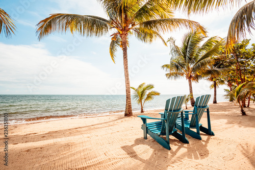 Chairs on tropical beach photo