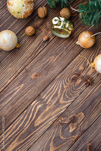 Christmas balls decor and nuts on old wood background with empty place for text