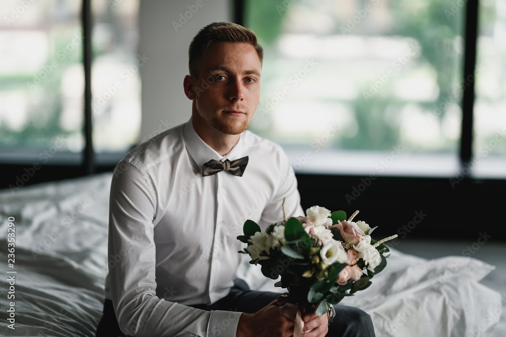 Stylish groom posing in a dark photo Studio. Morning newlyweds. Stylish groom posing in a dark photo Studio. Morning newlyweds.