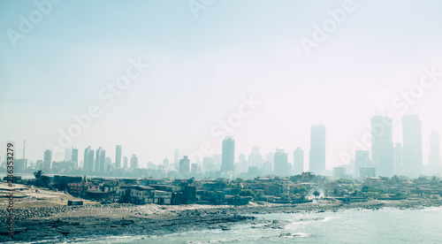 Slum under the pollution of the skyscraper skyline in Mumbai, India