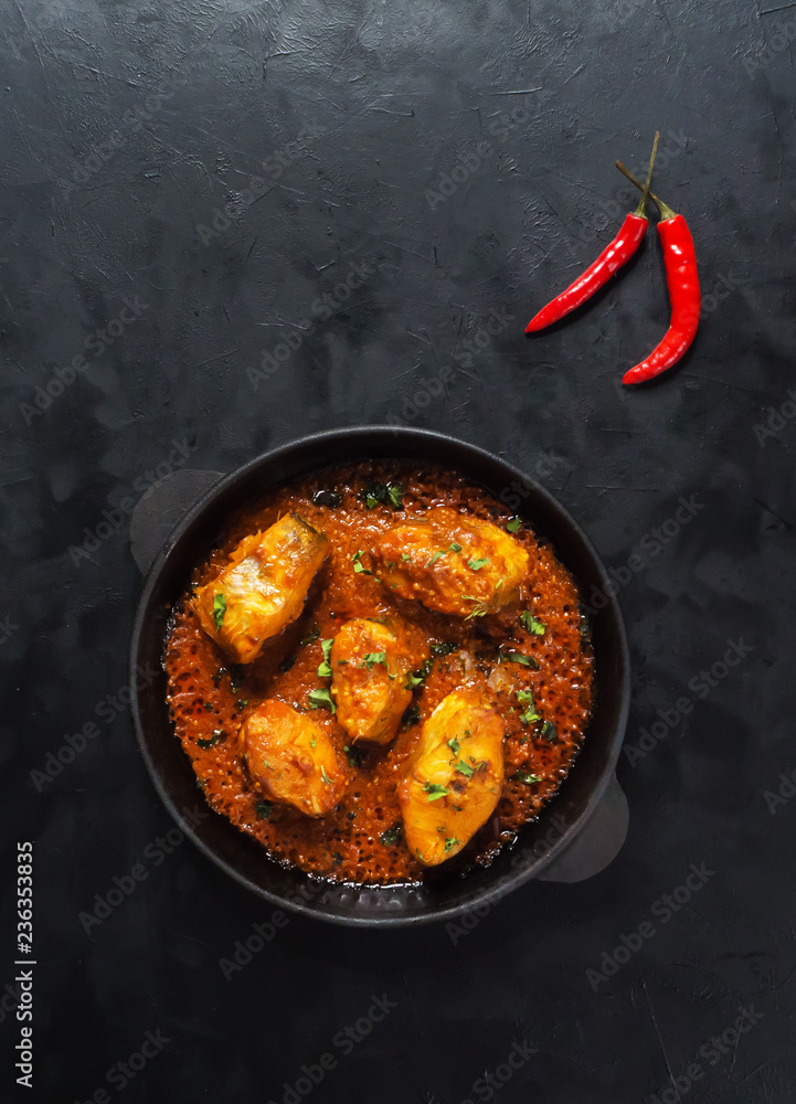 Top view of spicy and hot Bengali fish curry. Indian food. Fish curry with red chili, curry leaf, coconut milk. Asian cuisine.
 - obrazy, fototapety, plakaty 