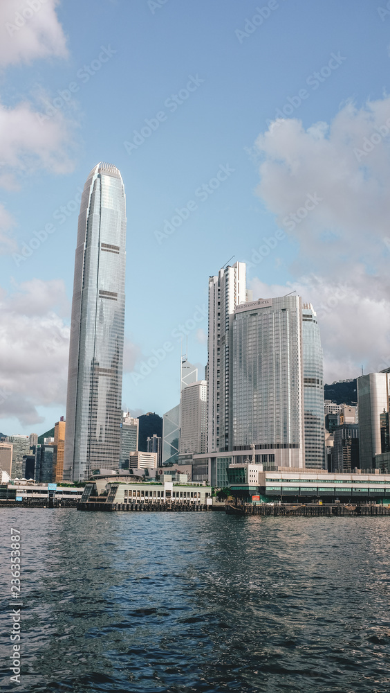 The Hong Kong skyline full of skyscrapers seen from the bay on a boat
