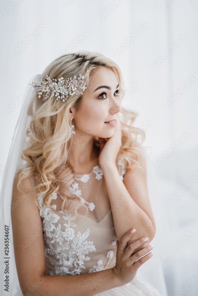 Beautiful blonde bride in a modern dress posing in the Studio. Morning newlyweds. Beautiful blonde bride in a modern dress posing in the Studio. Morning newlyweds.