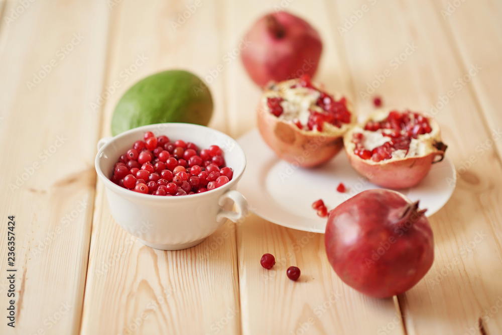 pomegranate, grapes, lime and cranberries on a wooden surface pomegranate, grapes, lime and cranberries on a wooden surface