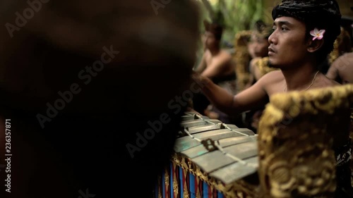 Asian Balinese musician gamelan group playing in traditional dress in a ceremonial celebration performance Indonesia South East Asia photo