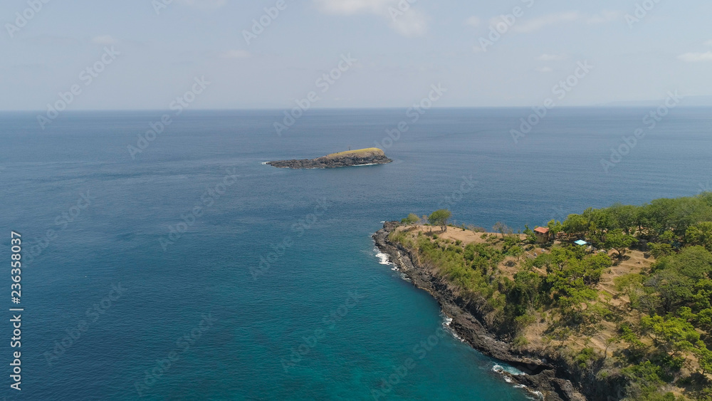 Lonely rocky island in the sea. Aerial view Uninhabited tropical island among the ocean. Travel concept.