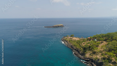 Lonely rocky island in the sea. Aerial view Uninhabited tropical island among the ocean. Travel concept.
